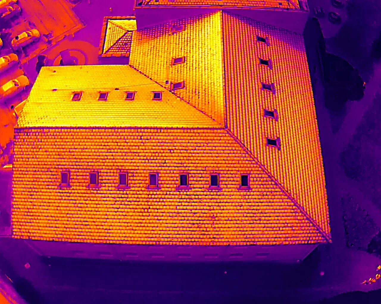 Aerial thermal image of a building roof showing heat signatures